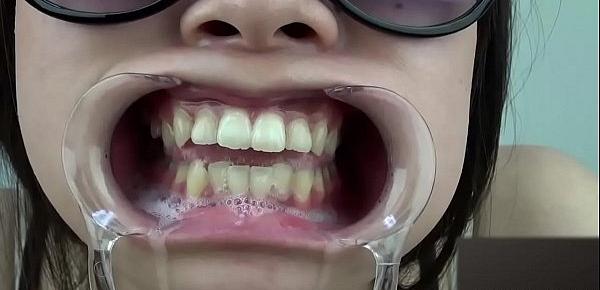  A woman shows her gums and sputs saliva